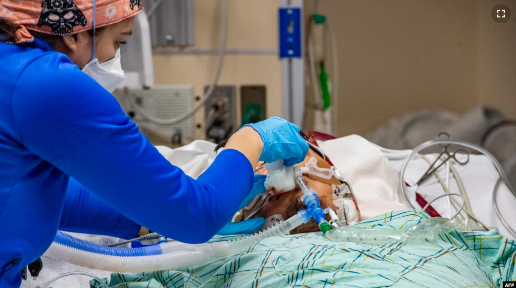 FILE - A medical worker treats an unvaccinated 40 year old patient who is suffering from the effects of Covid-19 in the ICU at Hartford Hospital in Hartford, Connecticut on January 18, 2022. (Photo by Joseph Prezioso / AFP)