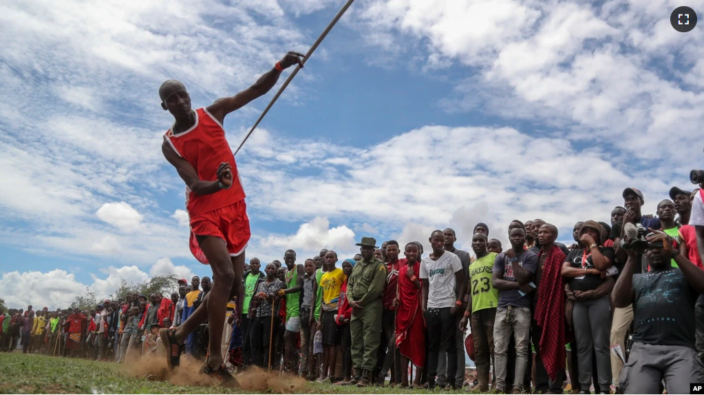 A Maasai man throws a javelin as he competes in the Maasai Olympics in Kimana Sanctuary, southern Kenya Saturday, Dec. 10, 2022. (AP Photo/Brian Inganga)