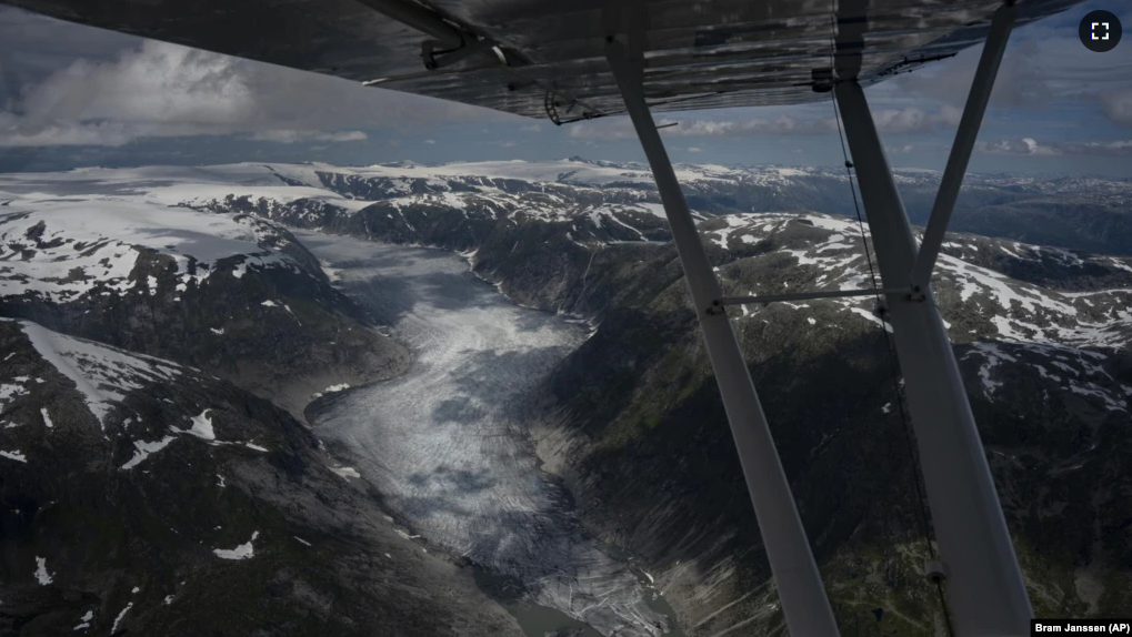 A glacier is seen from Garrett Fisher's plane in Norway on July 30, 2022. (AP Photo/Bram Janssen)