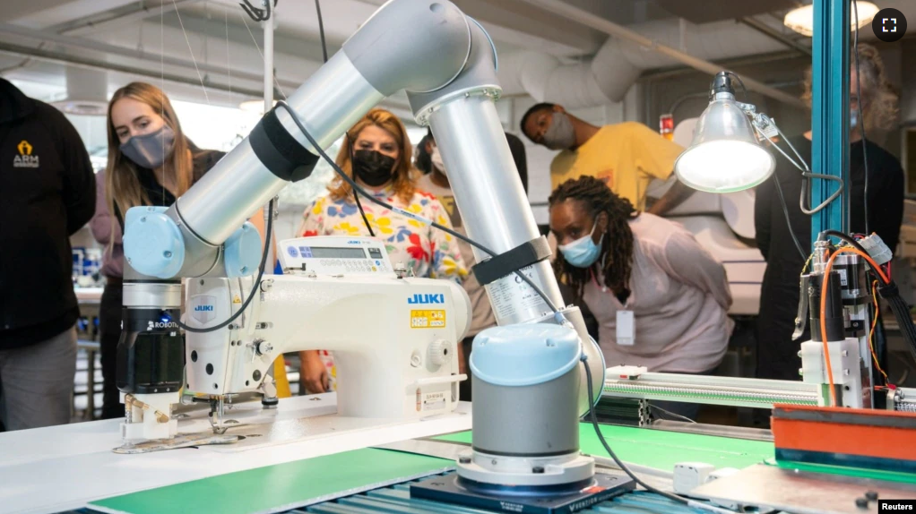 FILE - A robotic arm positions pieces of stiffened fabric for a demonstration of automated sewing at the Industrial Sewing and Innovation Center in Detroit, Michigan, U.S. August 19, 2021. (Industrial Sewing and Innovation Center/Handout via REUTERS)