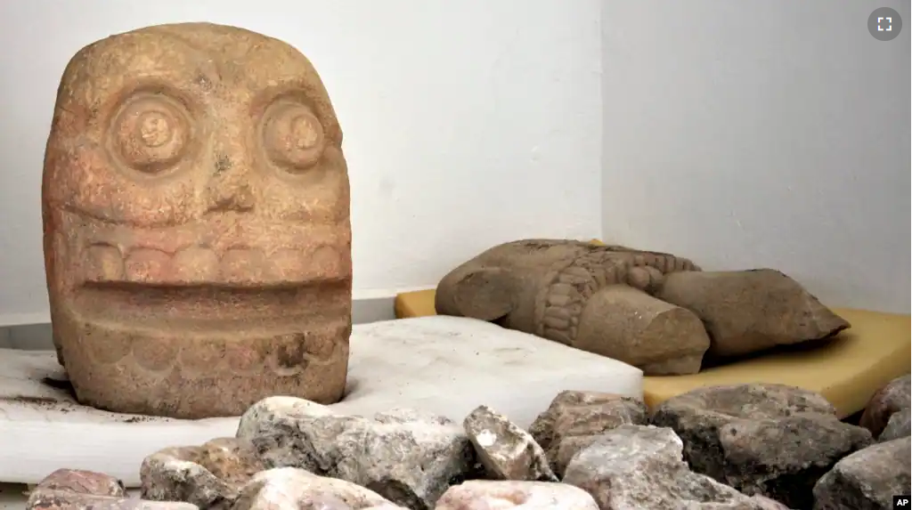 A skull-like stone carving and other parts representing the Flayed Lord are stored after being dug up from the Ndachjian–Tehuacan archaeological site in Tehuacan, Puebla state. This 2018 photo was provided by Mexico's National Institute of Anthropology.