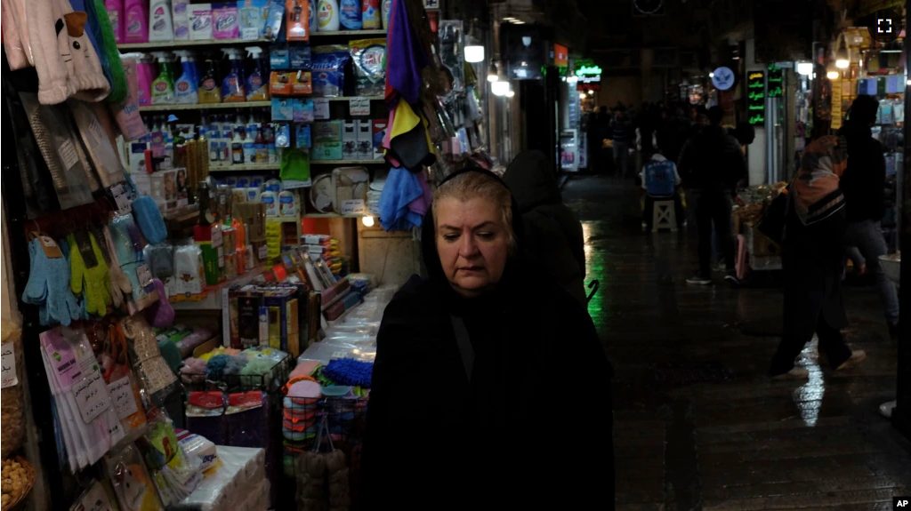 A woman walks through Tajrish bazaar in northern Tehran, Iran, Monday, Dec. 5, 2022. Confusion over the status of Iran’s religious police grew as state media cast doubt on reports the force had been shut down. (AP Photo/Vahid Salemi)