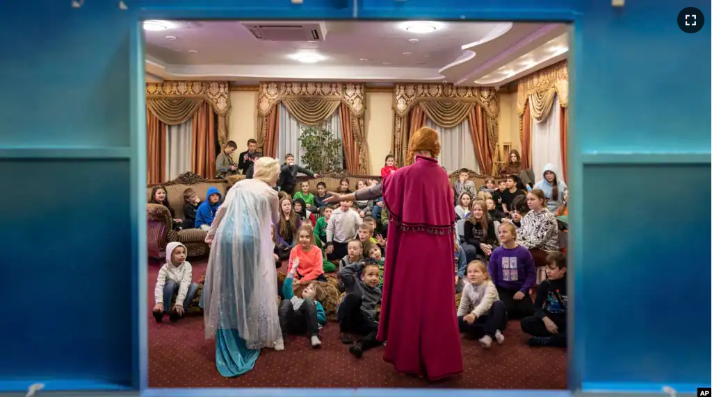 Actors perform to children at the Dzherelo rehabilitation center during celebrations for Saint Nicholas Day, in Kyiv, Ukraine, Monday, Dec. 19, 2022. (AP Photo/Evgeniy Maloletka)