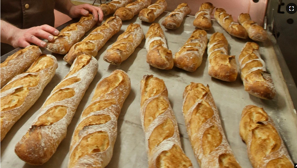 FILE - Baguettes are seen as they come out of the oven of the bakery La Parisienne in Paris, Friday, March 18, 2016. The bread has been recognized by UNESCO. (AP Photo/Michel Euler/File photo)