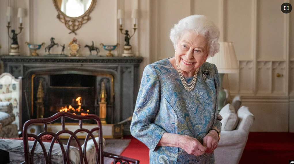 FILE - Britain's Queen Elizabeth II smiles while receiving the President of Switzerland Ignazio Cassis and his wife Paola Cassis during an audience at Windsor Castle in Windsor, England, Thursday, April 28, 2022.