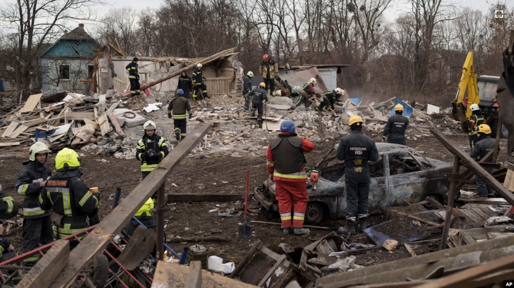 Emergency workers remove debris of a house destroyed following a Russian missile strike in Kyiv, Ukraine, Thursday, Dec. 29, 2022. (AP Photo/Roman Hrytsyna)