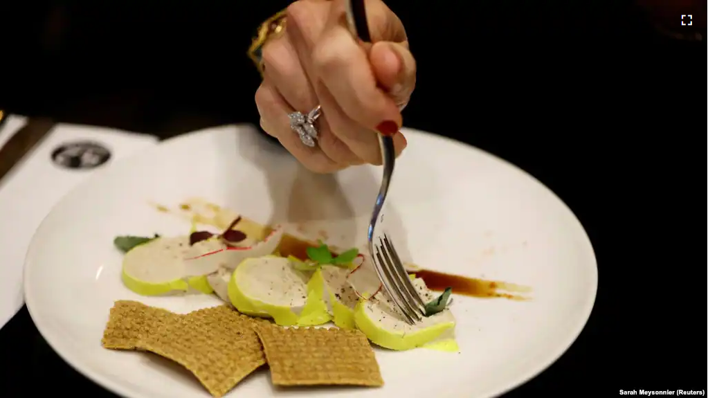 A woman eats 'Faux-gras', a vegan alternative to foie gras, in the restaurant "42 Degres" in Paris France, December 15, 2022. (REUTERS/Sarah Meyssonnier)