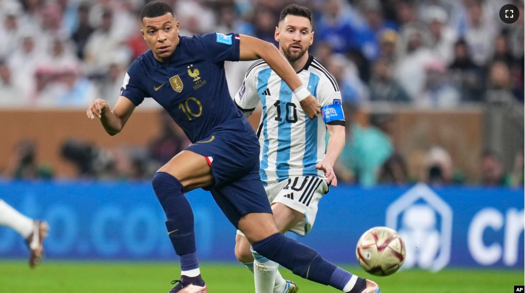 France's Kylian Mbappe and Argentina's Lionel Messi go for the ball during the World Cup final soccer match between Argentina and France at the Lusail Stadium in Lusail, Qatar, Sunday, Dec.18, 2022. (AP Photo/Manu Fernandez)