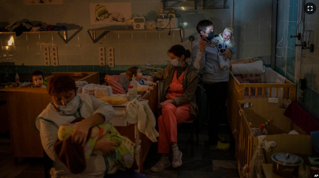 Hospital workers take care of orphaned children at the children's regional hospital maternity ward in Kherson, southern Ukraine on November 22, 2022. (AP Photo/Bernat Armangue)