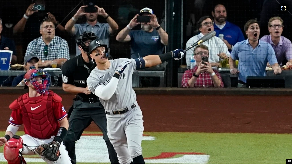 FILE - New York Yankees' Aaron Judge follows through on a solo home run, his 62nd of the season on Oct. 4, 2022. (AP Photo/Tony Gutierrez)