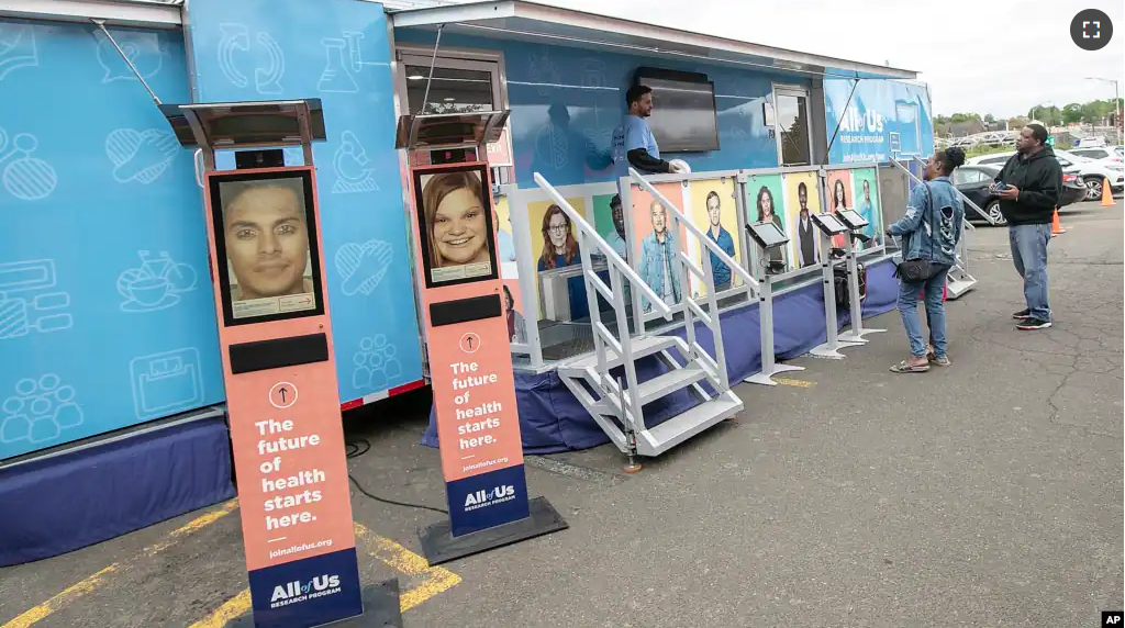 FILE - People stand by the All of Us Mobile Education and Enrollment Center at the Community Health Center on State Street in Meriden, Conn., May 13, 2019. (Dave Zajac/Record-Journal via AP, file)