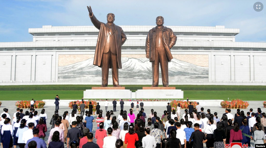 FILE - People visit the the statues of North Korea's founder Kim Il Sung and late leader Kim Jong Il on the 74th anniversary of North Korea's founding, in Pyongyang, North Korea on September 10, 2022. (KCNA via REUTERS)