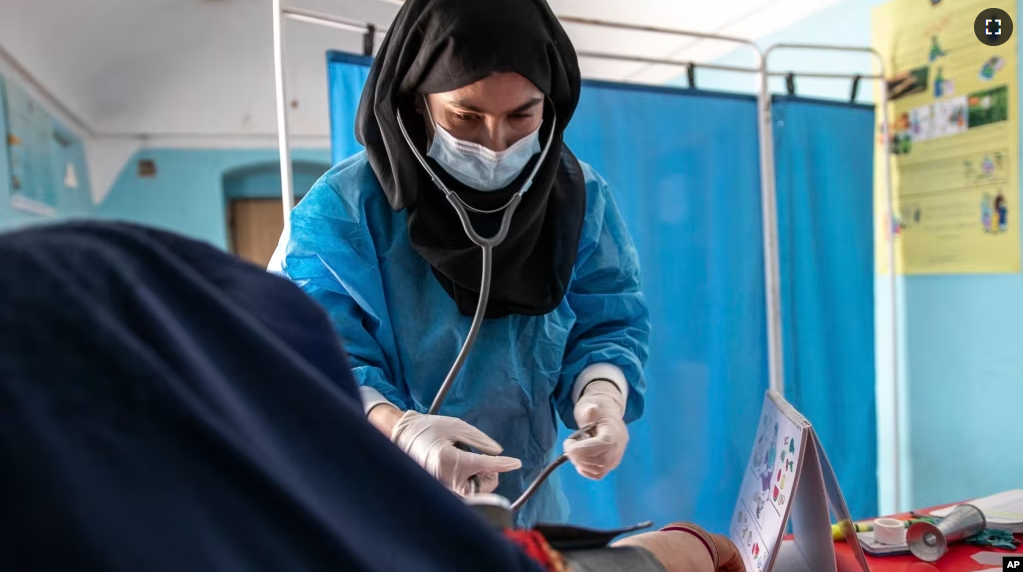 FILE - A Save the Children midwife provides Zarmina, 25, who is five months pregnant, with a pre-natal check-up in Jawzjan province in northern Afghanistan, Sunday, Oct. 2, 2022. (Save the Children via AP, File)