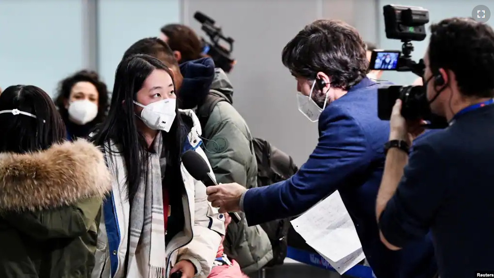 A passenger speaks to a reporter after Italy ordered COVID-19 tests for all travelers coming from China, December 29, 2022. (REUTERS/Jennifer Lorenzini)