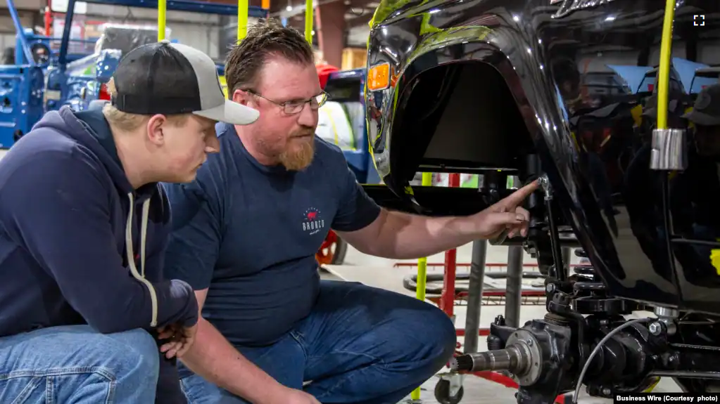 A student from McPherson College works restoring a Ford Bronco during a summer internship.