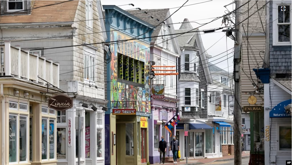 FILE - Closed retail stores line the usually crowded Commercial Street, Monday, May 25, 2020, in Provincetown, Mass. (AP Photo/Michael Dwyer)