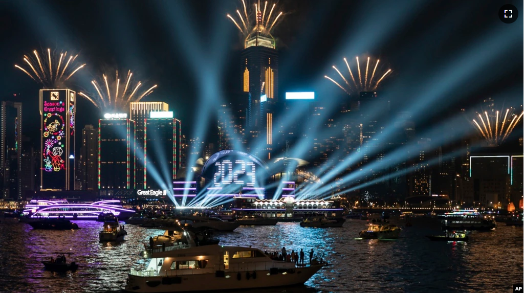 Fireworks are seen over Victoria Harbour at midnight on New Years Sunday Jan. 1, 2023 in Hong Kong. (AP Photo/Anthony Kwan)