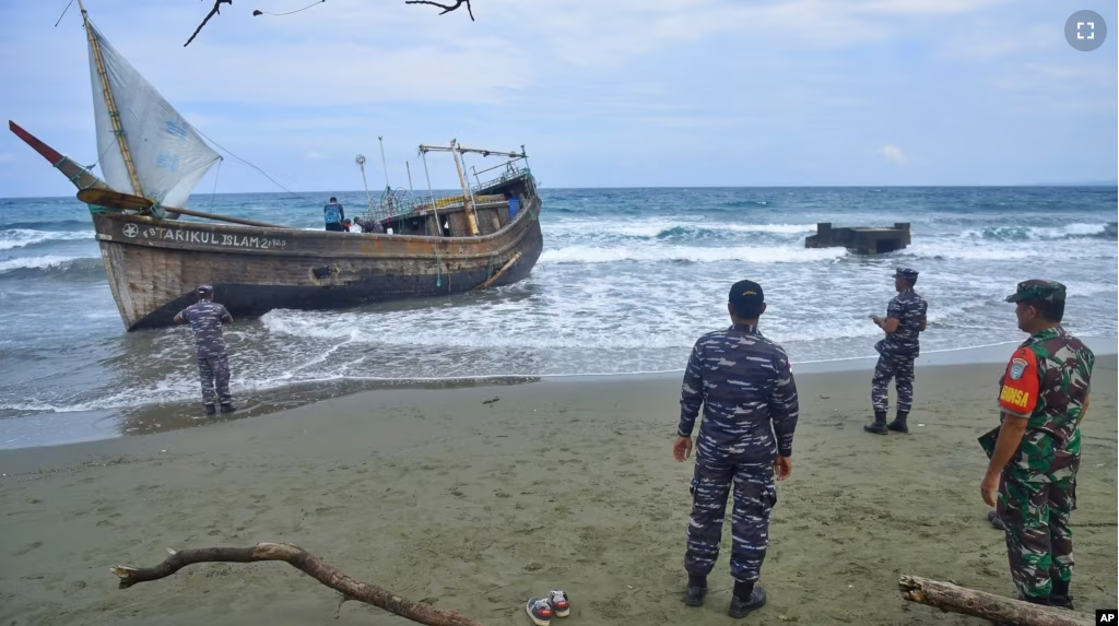 Indonesian military personnel inspect a boat used to carry Rohingya refugees after it landed in Aceh province, Indonesia, Sunday, Dec. 25, 2022. (AP Photo/Rahmat Mirza)