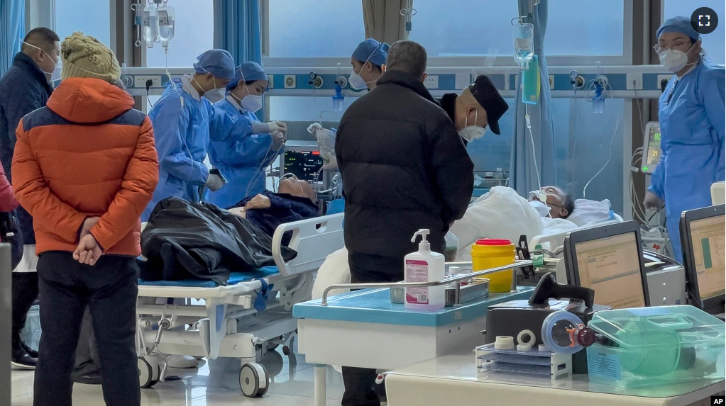 Medical workers check on an elderly patient arrives to an emergency hall in a hospital in Beijing, Saturday, Jan. 7, 2023. (AP Photo/Andy Wong)