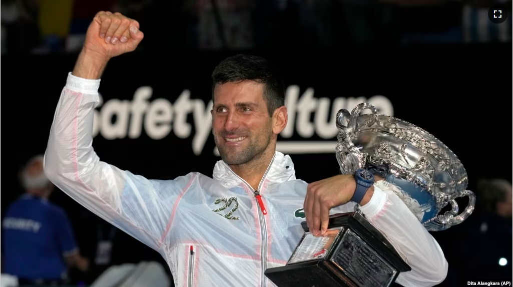 Novak Djokovic of Serbia gestures as he holds the Norman Brookes Challenge Cup after defeating Stefanos Tsitsipas of Greece in the men's singles final at the Australian Open tennis championship in Melbourne, Australia, Sunday, Jan. 29, 2023. (AP Photo/Dita Alangkara)