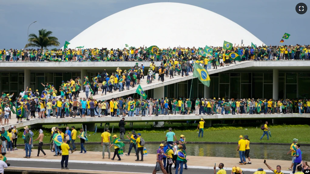 Protesters, supporters of Brazil's former President Jair Bolsonaro, storm the the National Congress building in Brasilia, Brazil, Sunday, Jan. 8, 2023. (AP Photo/Eraldo Peres)