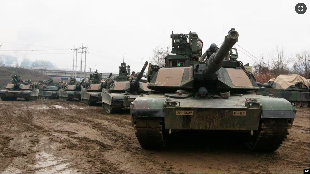 FILE - In this Dec. 10, 2015, file photo, U.S. M1A2 SEP Abrams battle tanks prepare to cross the Hantan river during an operation, part of an annual joint military exercise between South Korea and the United States. (AP Photo/Ahn Young-joon, File)