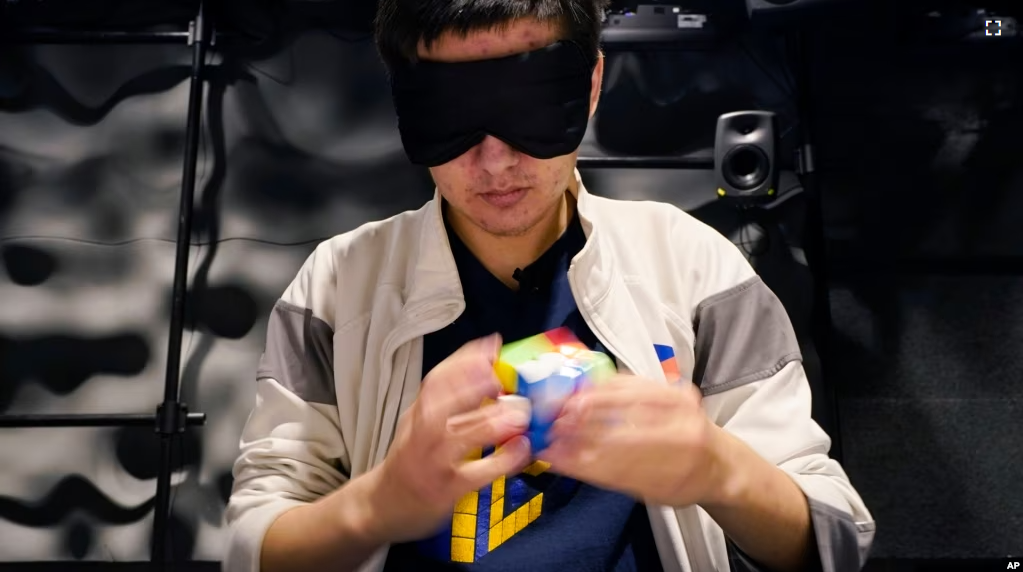 University of Michigan student Stanley Chapel solves a Rubik's Cube while blindfolded, Wednesday, Nov. 23, 2022, in Ann Arbor, Mich. (AP Photo/Carlos Osorio)