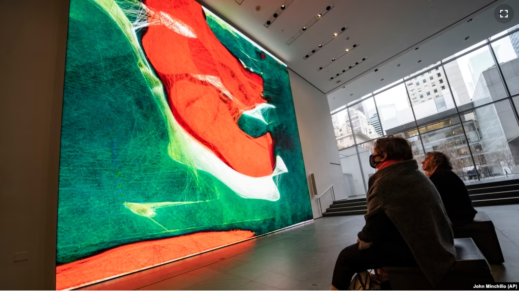 Visitors view artist Refik Anadol's "Unsupervised" exhibit at the Museum of Modern Art, Wednesday, Jan. 11, 2023, in New York. (AP Photo/John Minchillo)