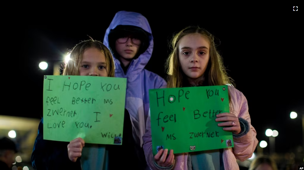 Willow Crawford, left, and her older sister Ava, right, join friend Kaylynn Vestre, center, in expressing their support for Richneck Elementary School first-grade teacher Abby Zwerner on Jan. 9, 2023. (AP Photo/John C. Clark)