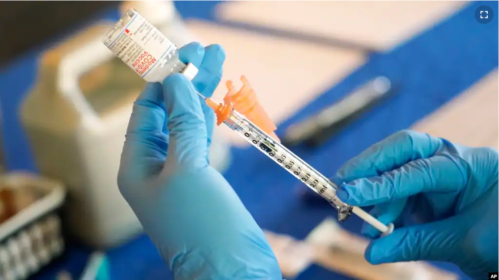 In this file photo, a nurse prepares a syringe of a COVID-19 vaccine at an inoculation station in Jackson, Miss., July 19, 2022. (AP Photo/Rogelio V. Solis, File)