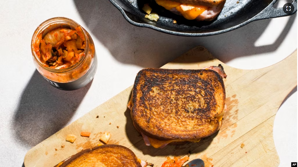 This image released by Milk Street shows a recipe for Kimchi Grilled Cheese with Ham. (Milk Street via AP)