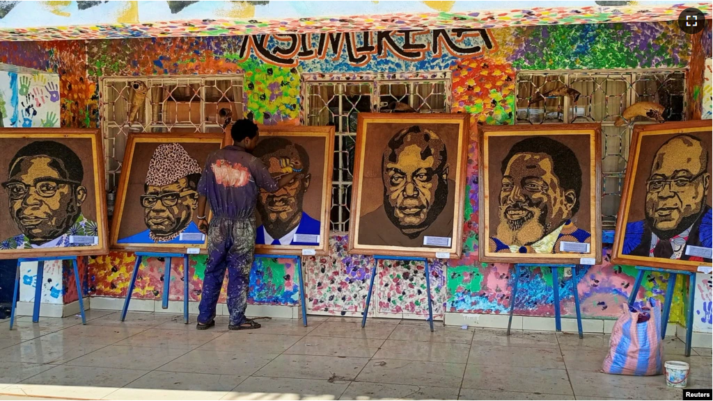 Congolese artist Patrick Cikuru Cirimwami applies finishing touches on pictures of Congolese leaders, made from plastic waste, collected near the Ruzizi I hydroelectric plant, in Bukavu, eastern Democratic Republic of Congo on December 15, 2022. (REUTERS/Crispin Kyalangalilwa)