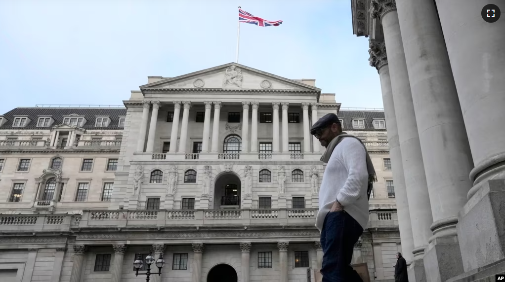 A man walks down steps in front of the Bank of England in London, Thursday, Feb. 2, 2023. (AP Photo/Frank Augstein)