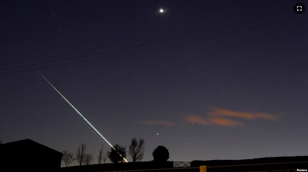 FILE - A meteorite creates a streak of light across the night sky over the North Yorkshire moors at Lealholm, near Whitby, northern England, April 26, 2015.