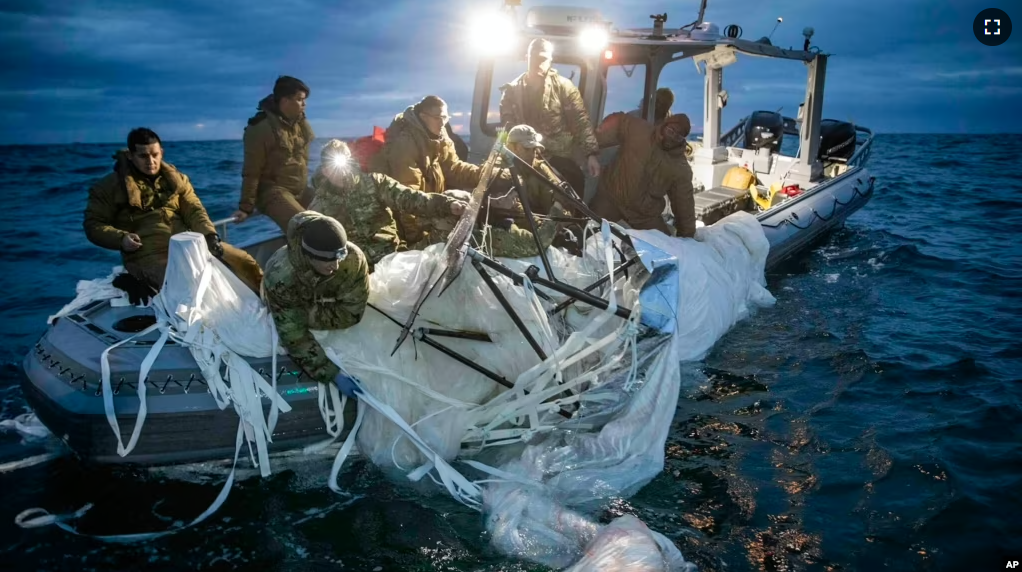 This image provided by the U.S. Navy shows sailors assigned to Explosive Ordnance Disposal Group 2 recovering a high-altitude surveillance balloon off the coast of Myrtle Beach, S.C., Feb. 5, 2023. (U.S. Navy via AP)