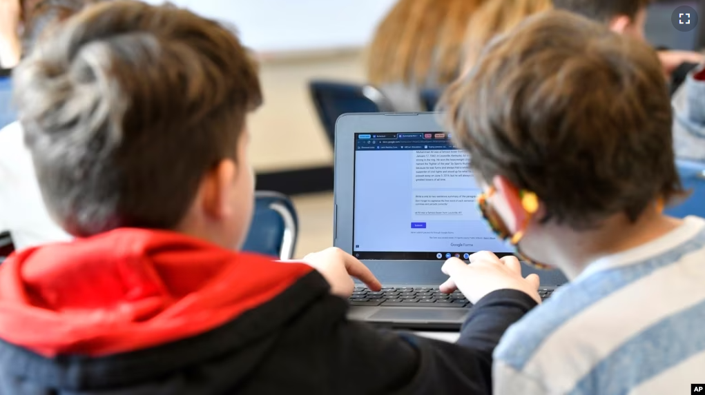 Michael Burton-Straub, left, and Declan Lewis attempt to "Find the Bot" in Donnie Piercey's class at Stonewall Elementary in Lexington, Ky., Monday, Feb. 6, 2023. (AP Photo/Timothy D. Easley)