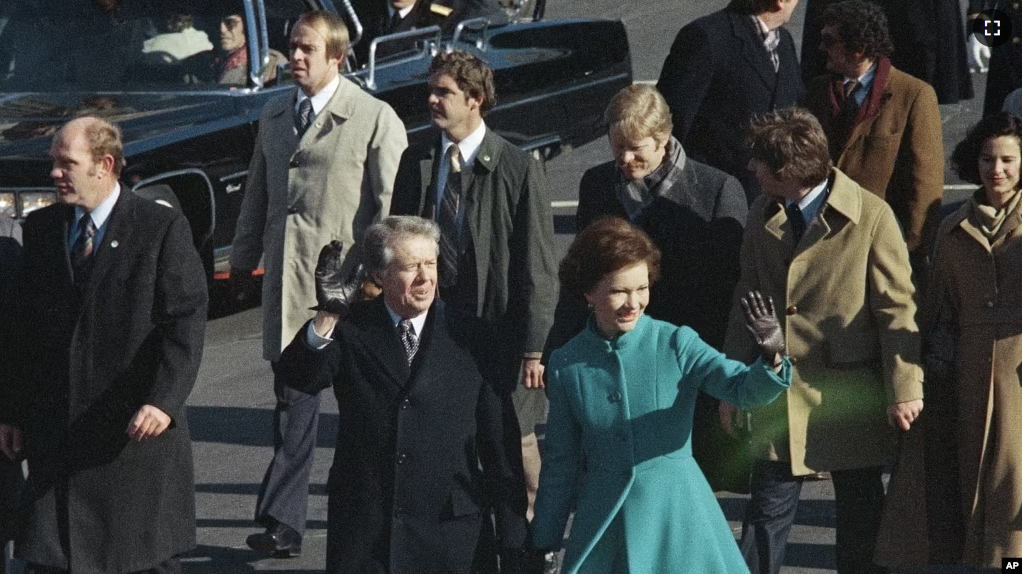 FILE - This Jan. 20, 1977 file photo shows President Jimmy Carter and First Lady Rosalynn Carter waving as they walk down Pennsylvania Avenue in Washington after Carter was sworn in as the nation's 39th president.