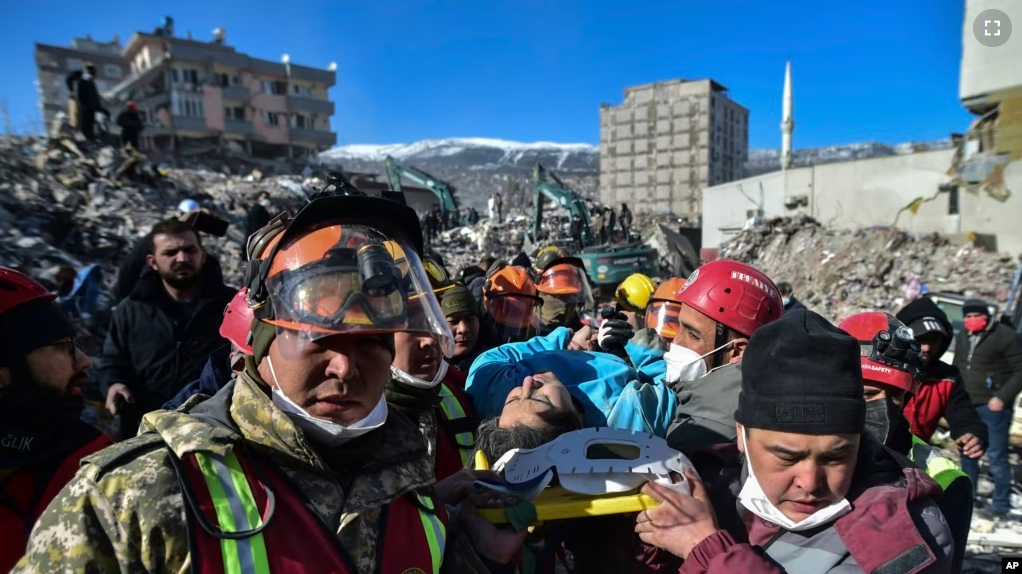 Turkish rescue workers from Kazakhstan and Turkey pull out Hatice Akar from a collapsed building 180 hours after the earthquake in Kahramanmaras, southern Turkey, early Monday, Feb. 13, 2023.