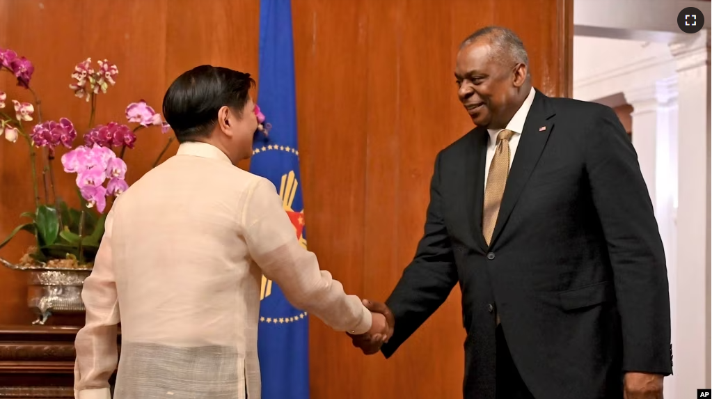 U.S. Secretary of Defense Lloyd James Austin III shake hands with Philippine President Ferdinand Marcos Jr. during a courtesy call at the Malacanang Palace in Manila, Feb. 2, 2023. (Jam Sta Rosa/Pool Photo via AP)