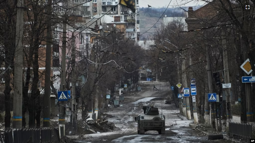 Ukrainian soldiers ride in a Humvee in Bakhmut, Donetsk region, Ukraine, Wednesday, Dec. 21, 2022. (AP Photo/Libkos, File)