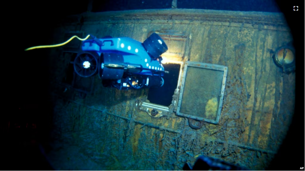 In this image from the Woods Hole Oceanographic Institution, an underwater remote vehicle examines an open window of the Titanic in 1986.