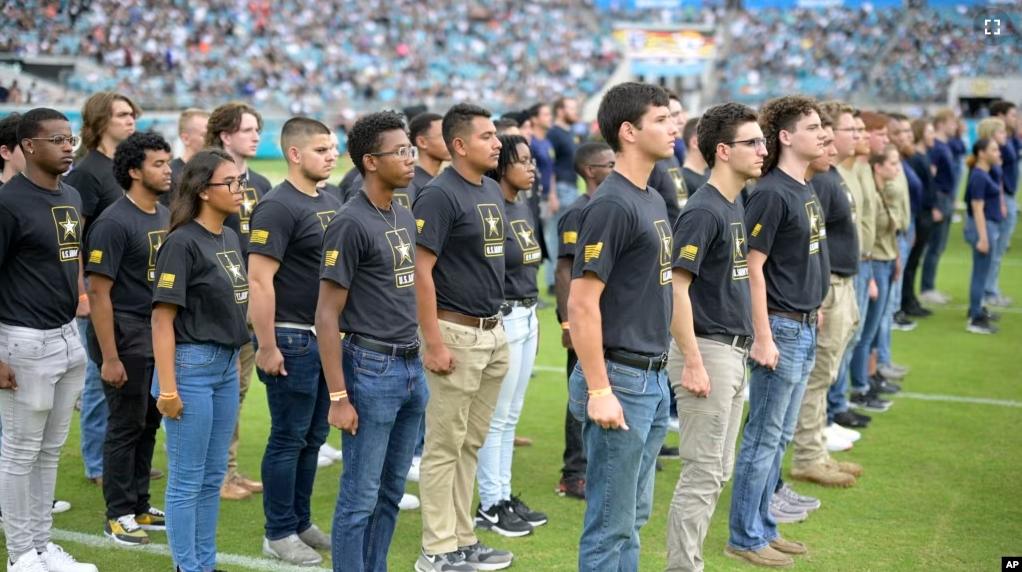 In this file photo, military recruits are sworn in during an NFL football game between the Jacksonville Jaguars and the Las Vegas Raiders, Nov. 6, 2022, in Jacksonville, Fla. (AP Photo/Phelan M. Ebenhack, File)