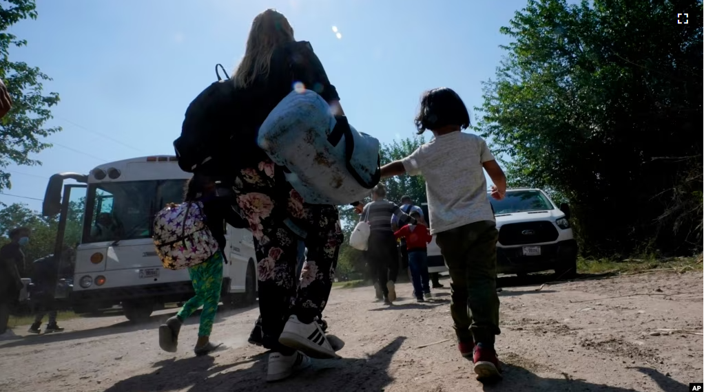 FILE - A migrant family from Venezuela walks to a Border Patrol transport vehicle after they and other migrants crossed the U.S.-Mexico border and turned themselves in June 16, 2021, in Del Rio, Texas. (AP Photo/Eric Gay, File)