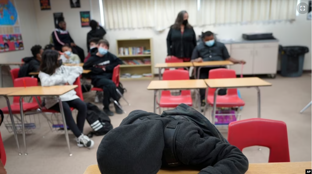 A student rests on his desk as the Mojave Unified School District in California. (AP Photo/Damian Dovarganes)