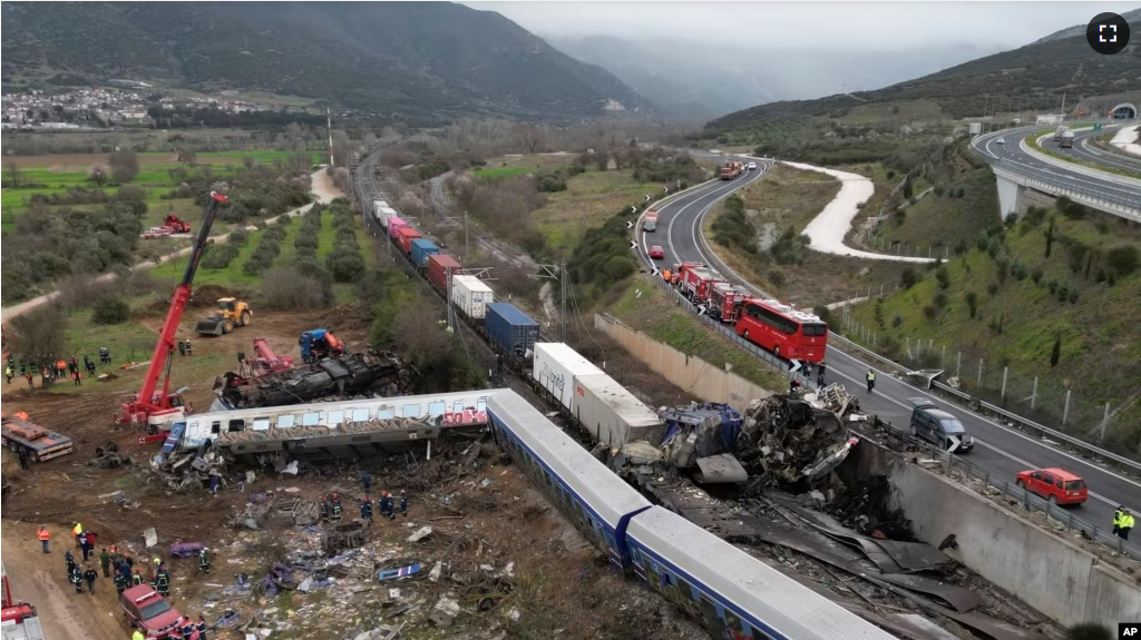 A train carrying hundreds of passengers has collided with an oncoming freight train in northern Greece, killing and injuring dozens of passengers. (AP Photo/Vaggelis Kousioras)