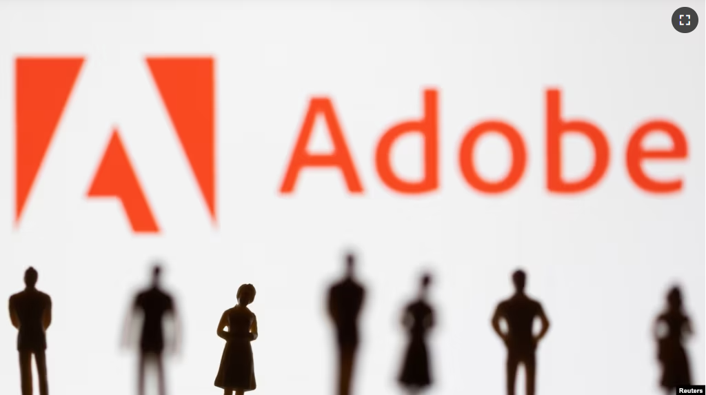 Figurines are seen in front of displayed Adobe logo in this illustration taken June 13, 2022. (REUTERS/Dado Ruvic/Illustration)