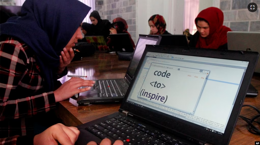 FILE - In this Sunday, Jan. 21, 2018 photo, Afghan women receive computer training center in Herat province, western Afghanistan. (AP Photo/Ahmad Seir)