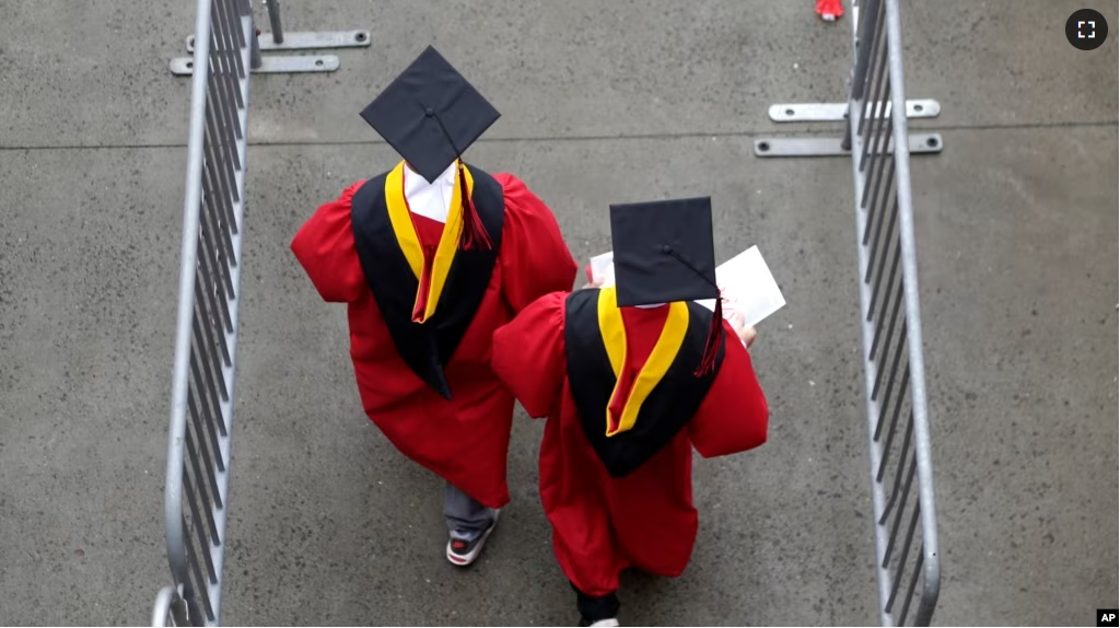 FILE - New graduates walk into the High Point Solutions Stadium before the start of the Rutgers University graduation ceremony, in Piscataway Township, New Jersey, May 13, 2018.