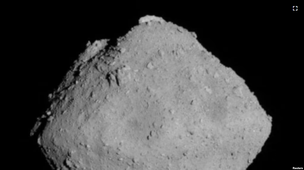 The carbonaceous asteroid Ryugu is seen from a distance of about 12 miles (20 km) during the Japanese Space Agency's Hayabusa2 mission on June 30, 2018.