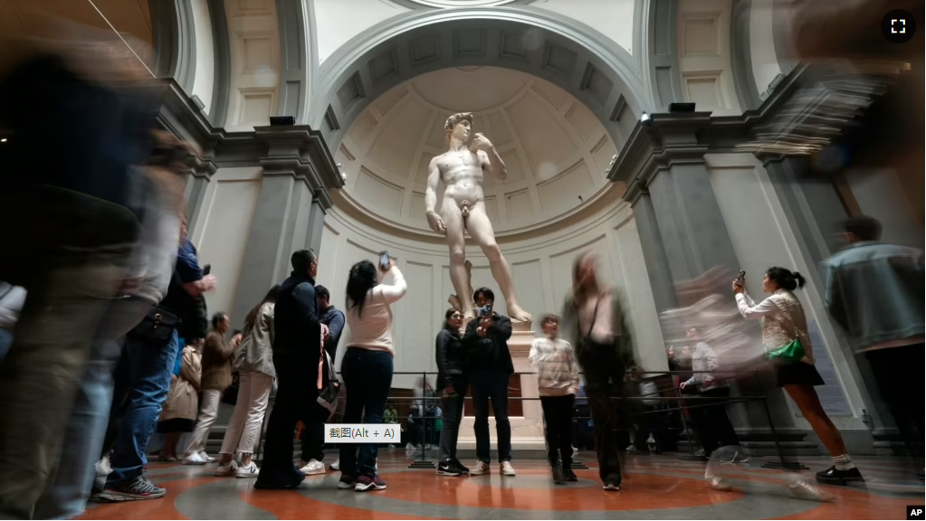 Visitors admire Michelangelo's "David" statue in the Accademia Gallery in Florence, Italy, Tuesday, March 28, 2023. (AP Photo/Alessandra Tarantino)